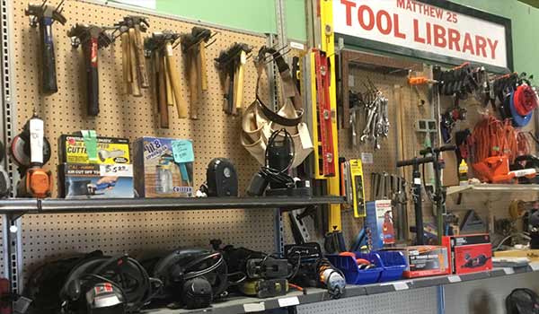 Many tools are on shelves or hanging from the wall