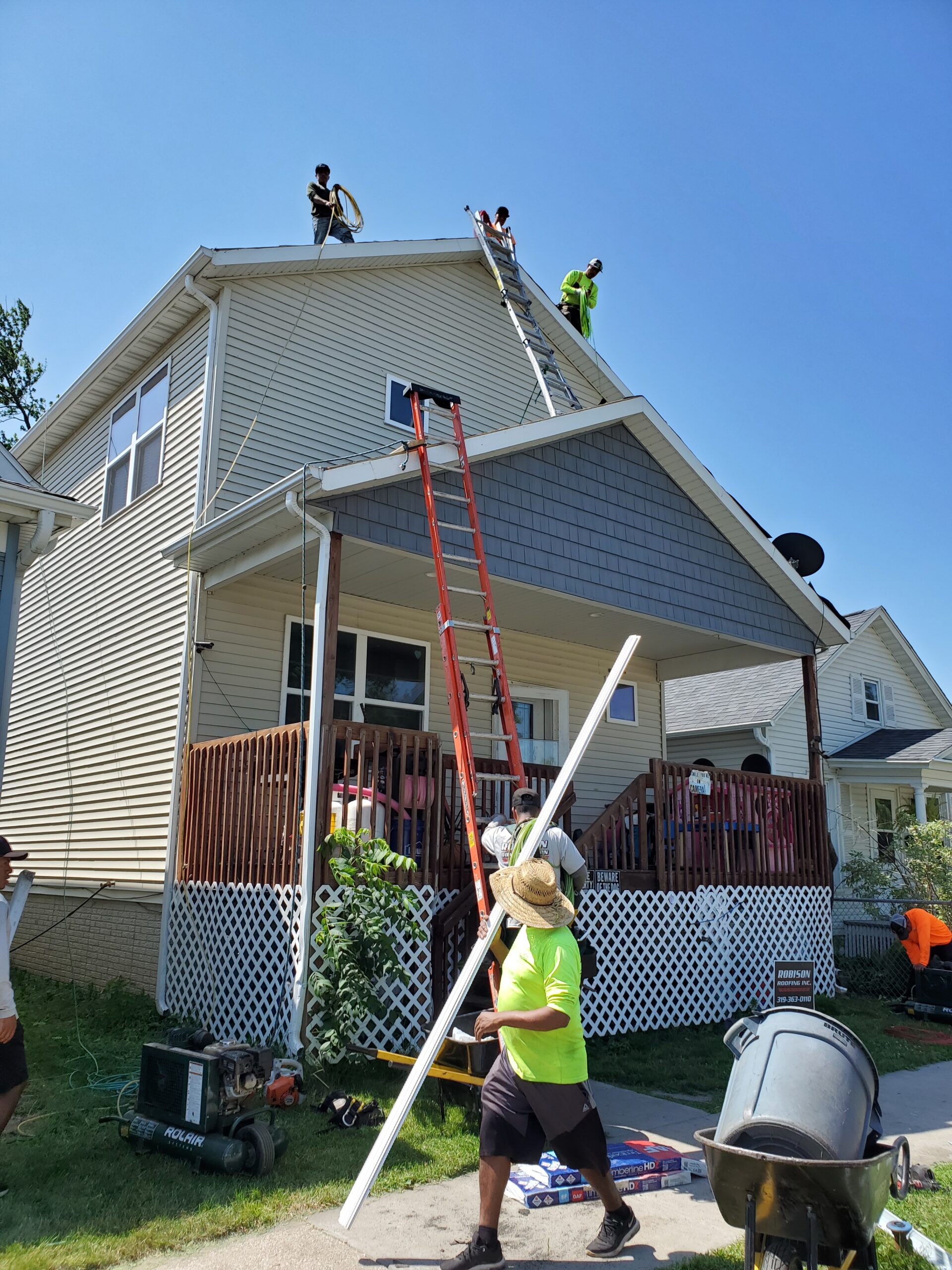 construction workers re-roofing a house