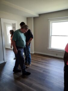 The Reinert family checks out the new floors and other changes in the main-level unit.